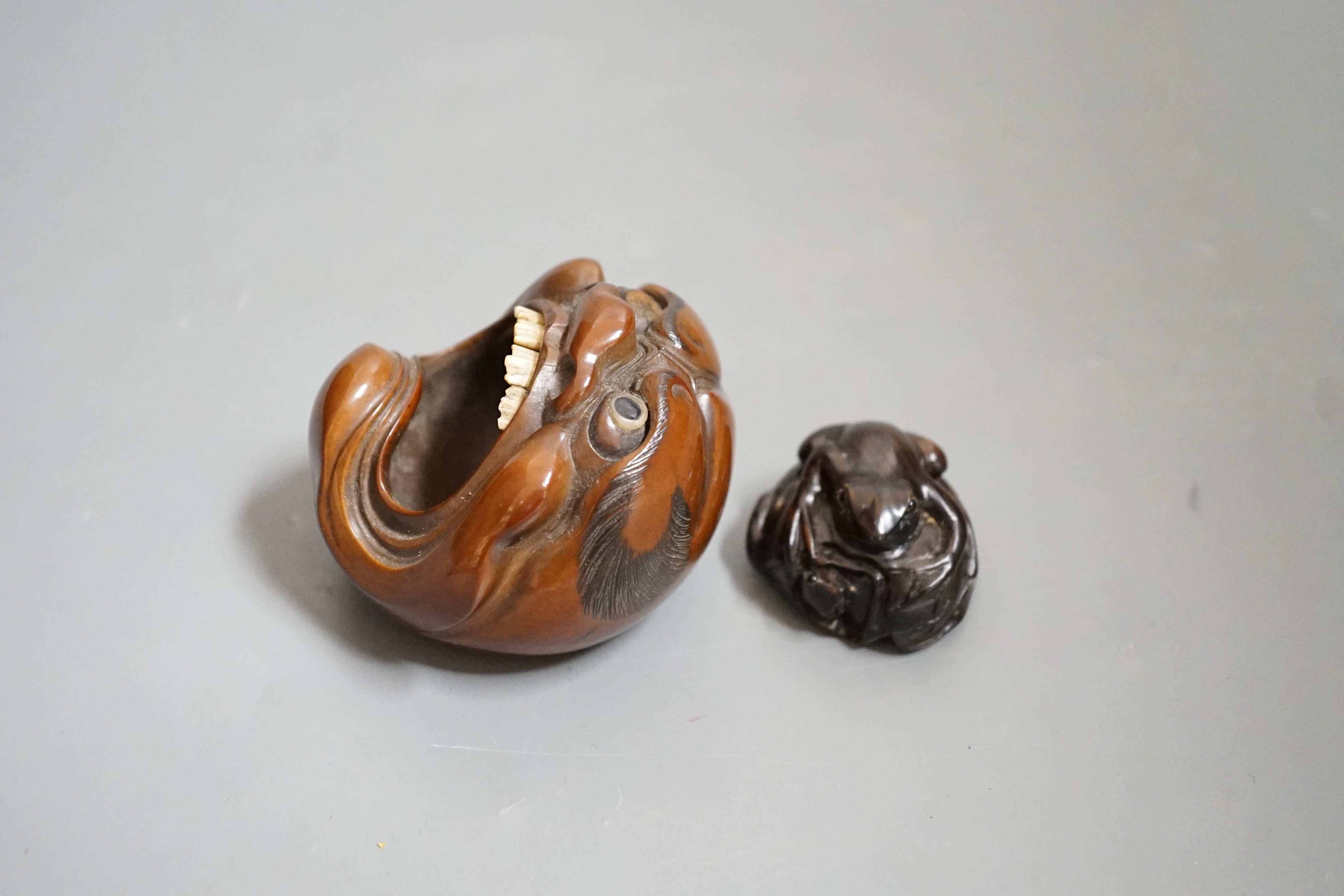 A Japanese mask nut carving wood carving, Meiji period and a netsuke of frogs, marks to bases, largest 7.5cm wide Ivory submission reference: 7BGTCJP8